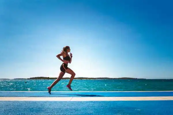 Woman running showing strong leg muscle Cumbernauld